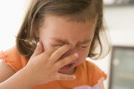 Young girl indoors crying