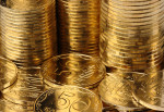 Extreme closeup of golden coins, columns and a heap