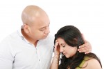 Husband comforts young wife, isolated on white